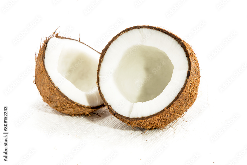 two halves of an opened coconut showing the white meat inside isolated on white two halves of an opened coconut showing the white meat inside isolated on white
