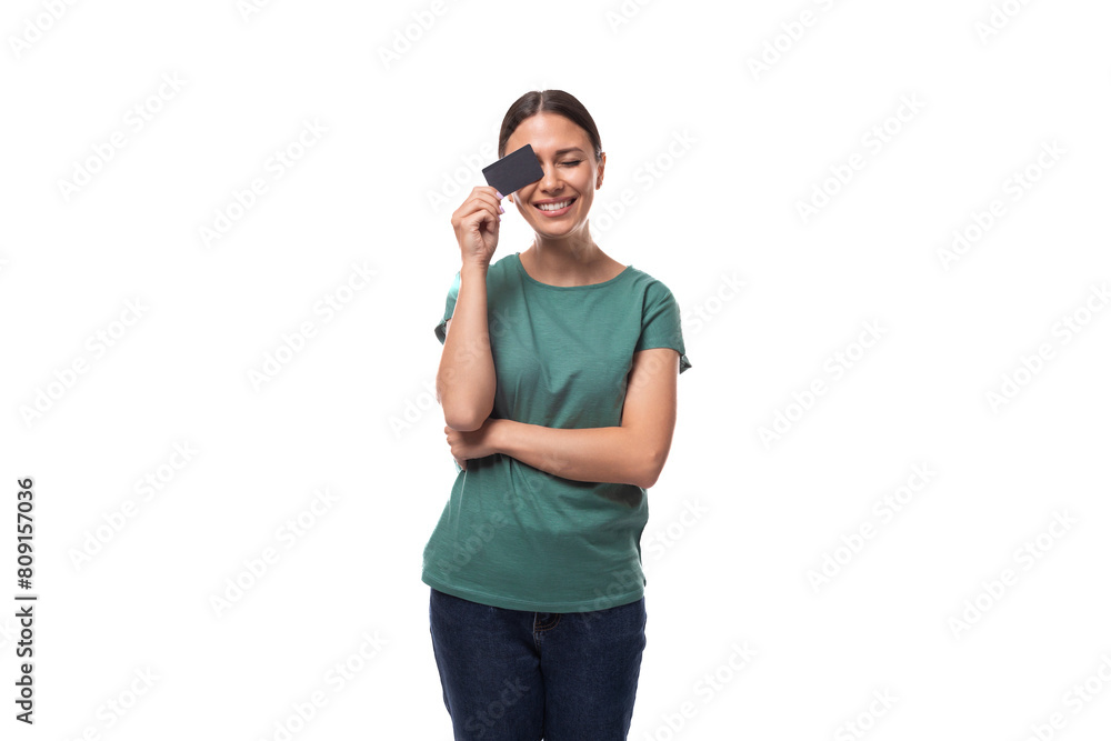 young black-haired woman dressed in a basic t-shirt holding a credit card young black-haired woman dressed in a basic t-shirt holding a credit card