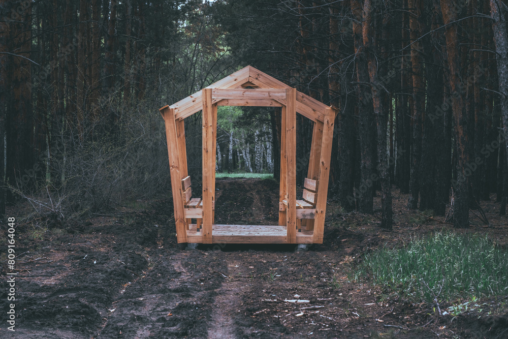 Wooden entrance to the forest. The concept of walking in the woods.