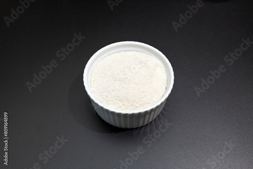 Celtic Gray Sea Salt In Ceramic White Bowl on Dark Table, Horizontal. Natural, Unrefined Salt Harvested From Brittany, France. Natural Minerals, Trace Element, Superfood. Ingredient, Seasoning