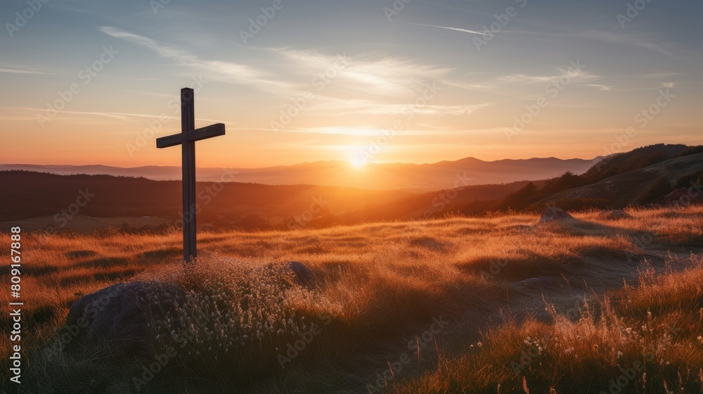 Dramatic sunset over a cross in a field