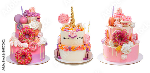 Elegant pink layered cakes for a girl or a woman. Isolated on white background with copy space for text. Decorated with donuts and unicorn