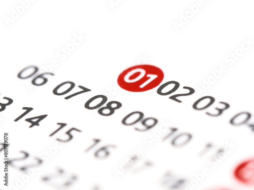 White paper calendar with the number 1 one in a red circle. The first 1st day of the month on a calendar