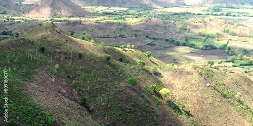 aerial video of deforested forests in mountainous areas being converted into agricultural land