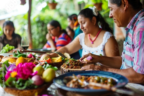 A group of people  likely a Colombian family  sitting at a table with plates of traditional food  enjoying a meal together  A Colombian family enjoying a traditional meal together