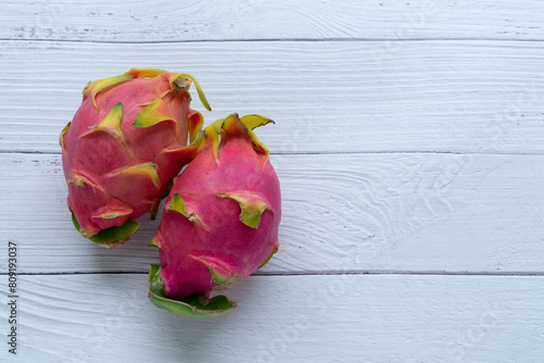 Two beautiful pitayas or dragon fruit on white background. Copy space. photo