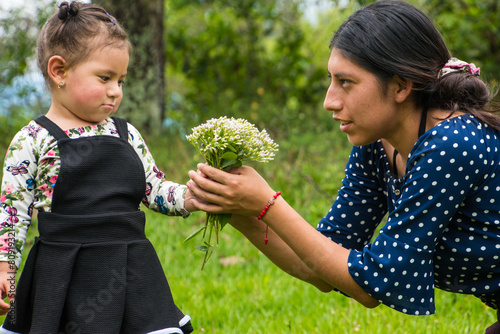 Giving a bouquet of flowers to his mother