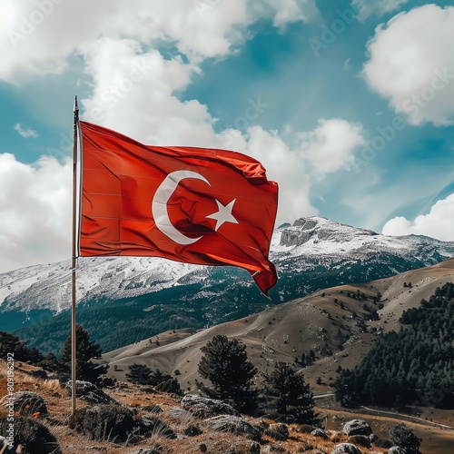 Turkish flag waving proudly on a mountaintop. The flag is a symbol of Turkey's independence and sovereignty. photo
