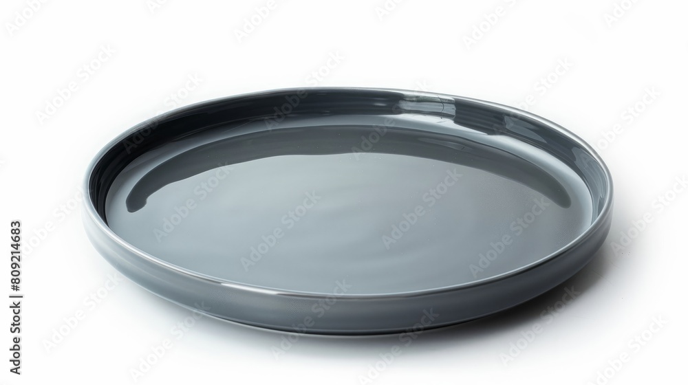 A simple yet elegant gray ceramic plate presented isolated on a pure white background A simple yet elegant gray ceramic plate presented isolated on a pure white background
