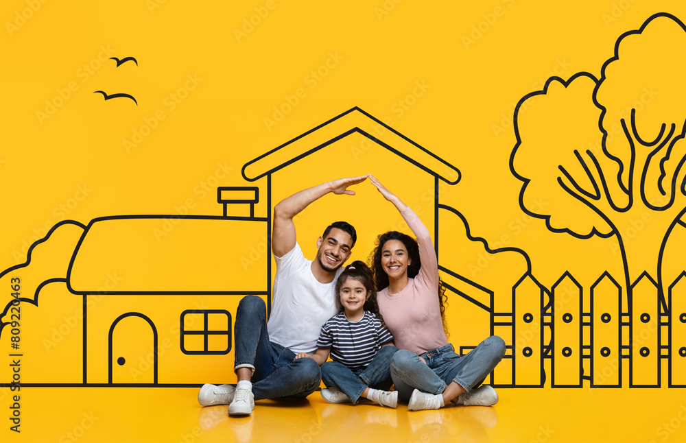 © Prostock-studio - Middle eastern family consisting of parents and daughter sit on the floor. In front of them is a large drawing of a house, possibly a dream home. They appear to be discussing or admiring the artwork. © Prostock-studio - Middle eastern family consisting of parents and daughter sit on the floor. In front of them is a large drawing of a house, possibly a dream home. They appear to be discussing or admiring the artwork.