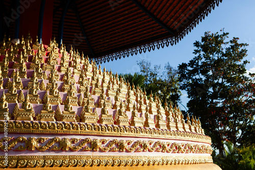 Golden Buddha images placed in circular order at Wat Chomkao Manilat, Houayxay, Laos. photo