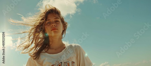 Beautiful girl on a beach. Outdoor shot. Portrait of a serious teen girl. Young woman against the sky.
