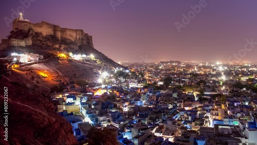 ndia, Rajasthan, Jodhpur, Pachetia Hill, elevated panoramic night view of the illuminated blue city dominated by Fort Mehrangarh photo