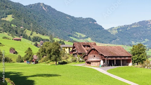 Switzerland, canton of Schwyz, Lauerz, panoramic view of a barn surrounded by lawn and view of Lake Lauerz, surmounted by Mount Rigi photo