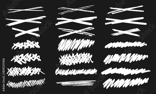 Strikethroughs and scribbles. Collection of twenty one freely drawn white squiggles and doodles on a black background. Vector set of handwritten symbols and signs photo