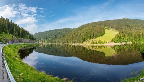 stunning panorama background from the mummelsee in the black forest on the black forest high road with reflection in the water