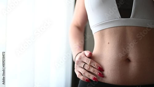 A woman showing her stretch marks on her stomach. photo
