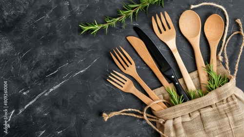 a fork and knife wrapped in a burlap napkin, adorned with a fragrant rosemary sprig, evoking a charming countryside theme with a touch of natural beauty.