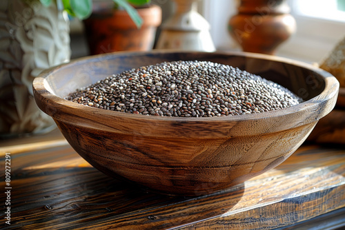 Chia seeds in wooden bowl. A grain bowl of chia seeds on wooden cloth photo