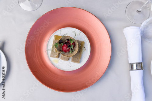 Top view of a foie gras,  goose liver pate, served on a plate in the restaurant