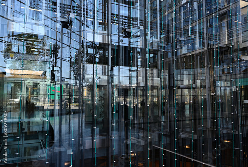 elevators behind a glass wall in an office building