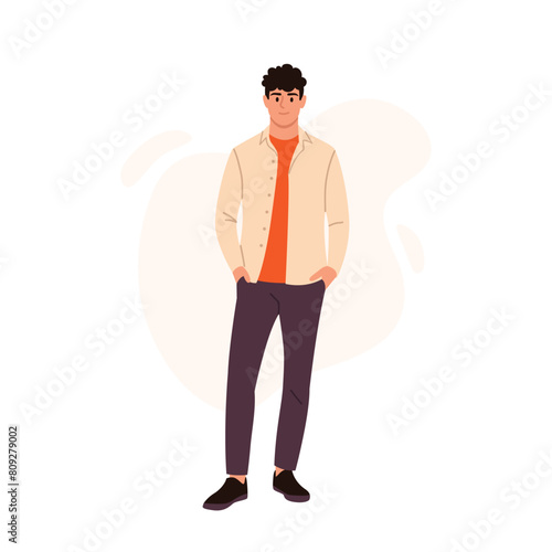 Vector illustration of a handsome fashionable guy. Cartoon scene of smiling, stylish guy with curly hair, hands in pockets, in orange t-shirt, beige shirt, pants, shoes isolated on white background. © MVshop