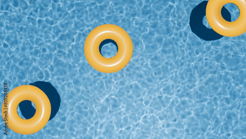 Summer holidays banner. Swimming pool top view. Three yellow swimming rings in the empty clear pool. © AndS