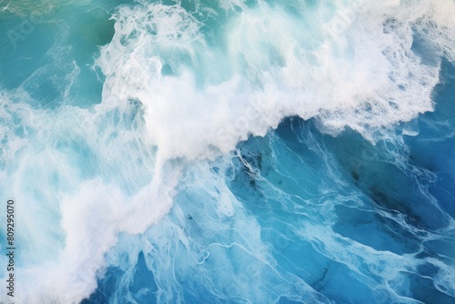 Aerial view of vibrant turquoise ocean waves with white foam © juliars