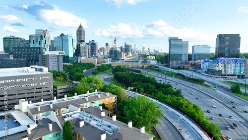 Smooth 4K panoramic footage of the Atlanta skyline with moving traffic in the foreground. The scene captures the dynamic energy of the city as vehicles flow along busy highways beneath a backdrop 