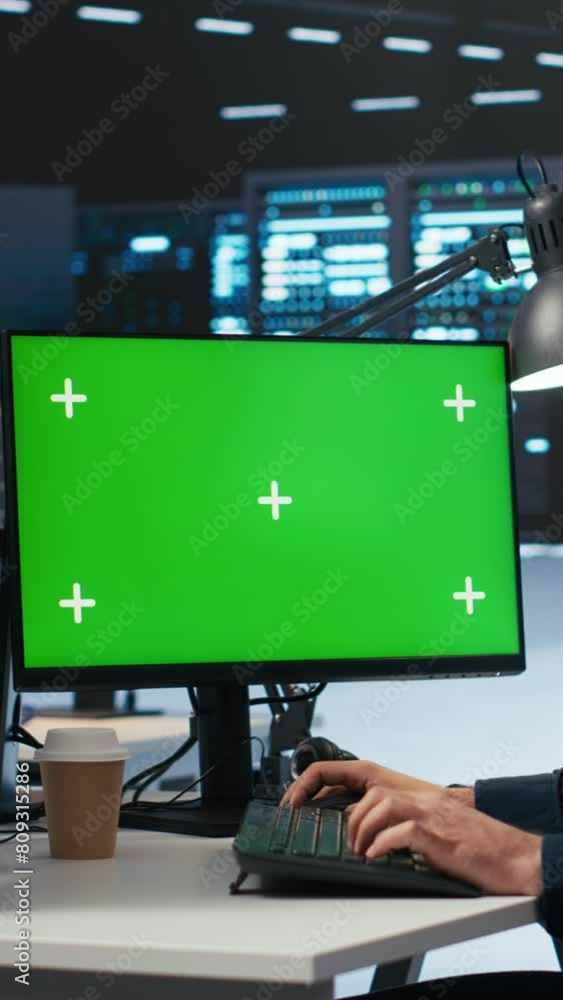 Vertical video IT employee programming on green screen PC in data ...