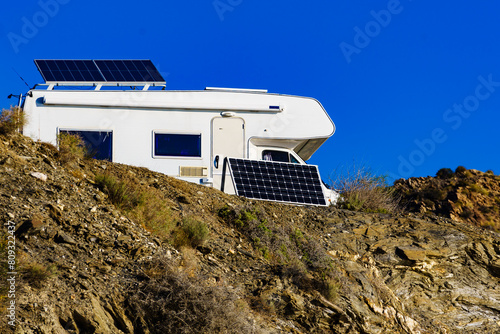 Caravan with tilt solar panels on roof.