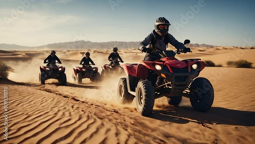 People on ATVs ride through the sunny desert photo