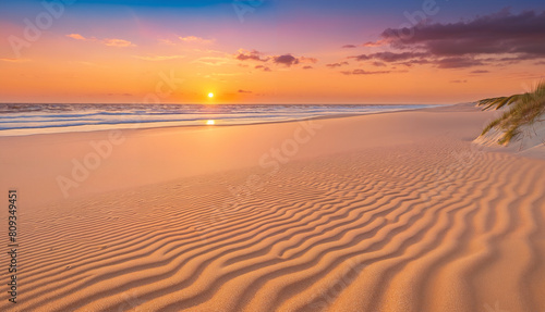 A beach scene at sunset  with the sun setting over the ocean. The beach is sandy. The sky is filled with clouds  creating a beautiful and serene atmosphere.