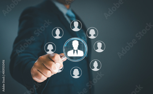 Human resource management concept. Businessman uses magnifying glass look employees teamwork business or Customer Relation Management focus target group social media. Digital marketing online. CRM