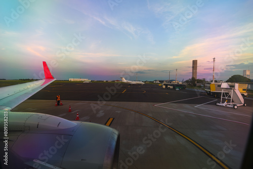 View from the airplane window of the airport taxiway. View from the plane window.