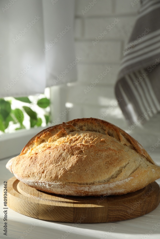 Freshly baked sourdough bread on white wooden table indoors Freshly baked sourdough bread on white wooden table indoors