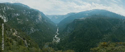 Panoramic view of Yosemite with it river  mountains and peaks.