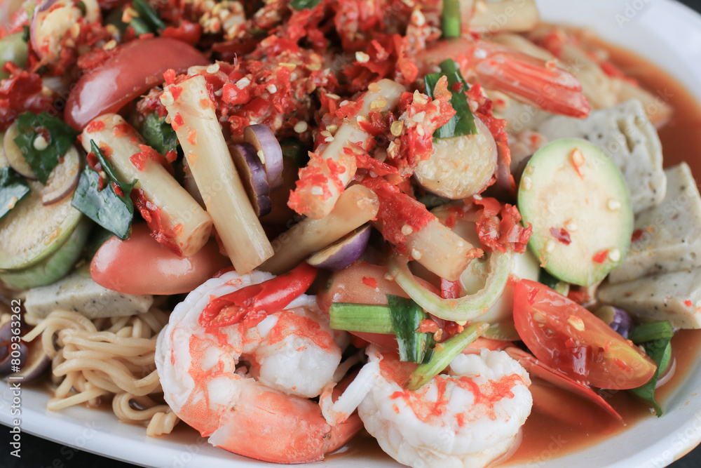 Instant noodles spicy salad with shrimp and vegetable on black table. Yum Mama Thai cuisine Yum traditional spicy hot Instant noodles spicy salad with shrimp and vegetable on black table. Yum Mama Thai cuisine Yum traditional spicy hot