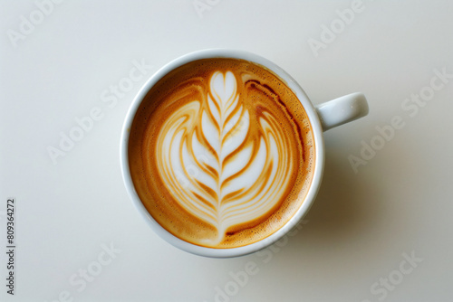 a cup of coffee with a leaf pattern on it