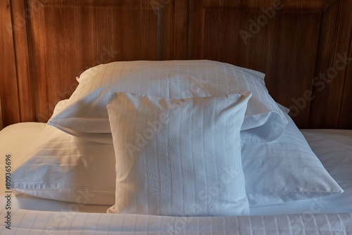 Hotel bed with white sheets, cozy lighting photo