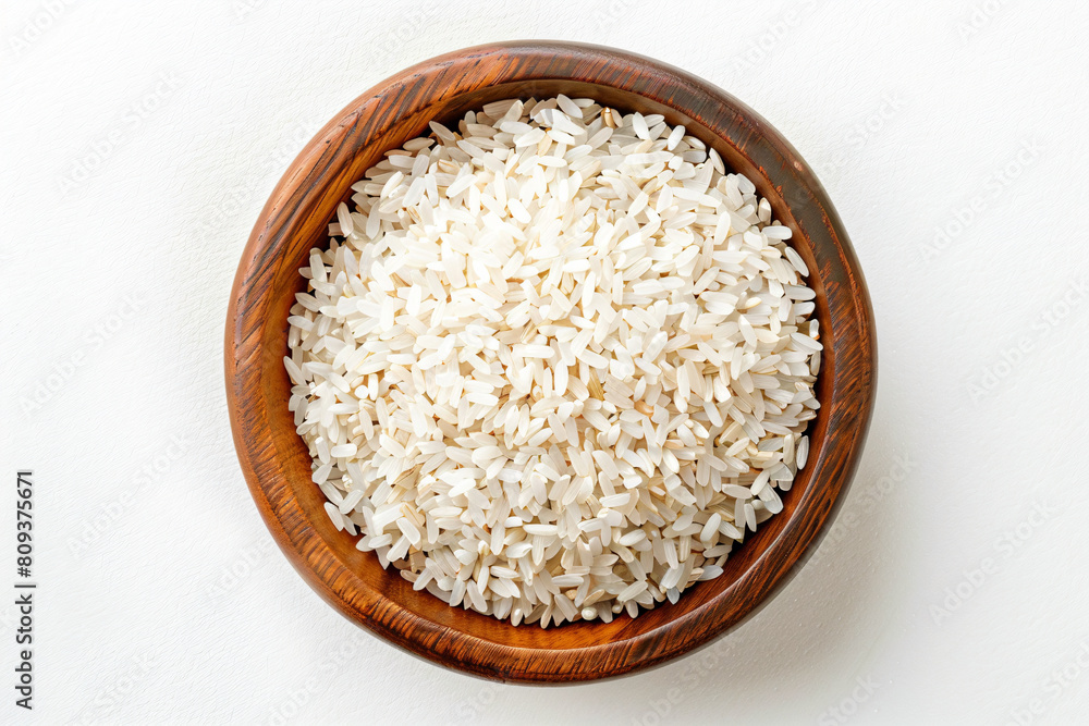 a wooden bowl filled with rice on top of a white table a wooden bowl filled with rice on top of a white table