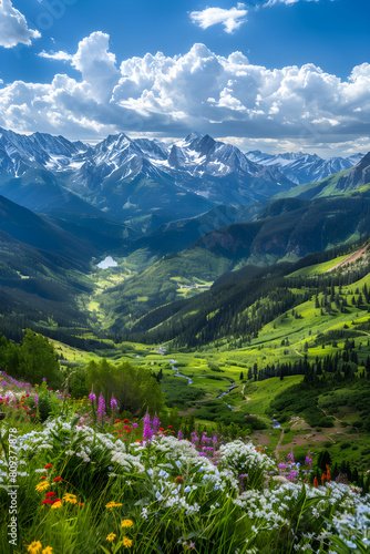 Breathtaking Panorama of Snow-capped US Mountains Amidst Vibrant Greenery and Bright Azure Sky