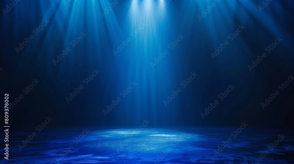 Fototapeta premium Dark blue background with light rays, glowing and shining on the floor, creating an atmospheric effect.