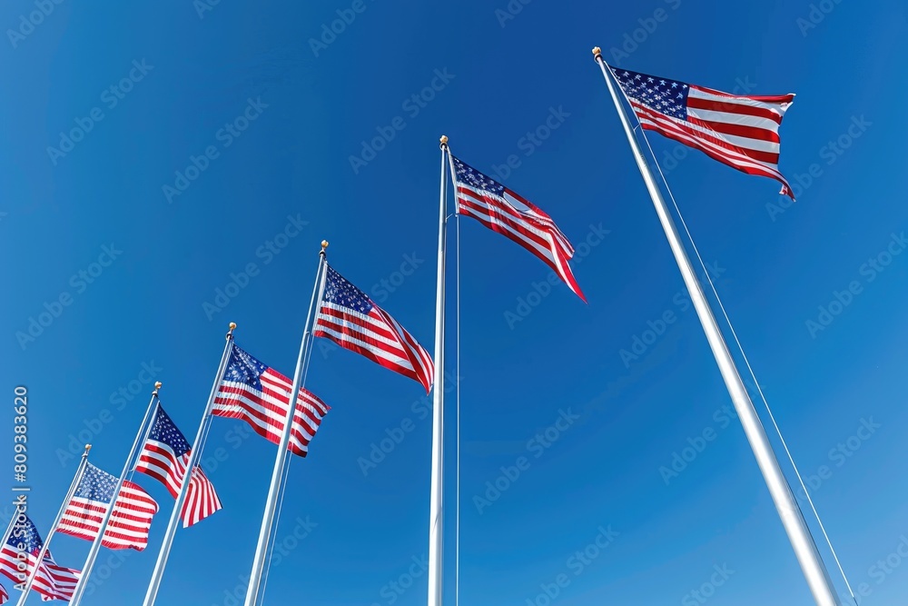 American flags waving in the wind on a background of blue sky. American flags waving in the wind on a background of blue sky.