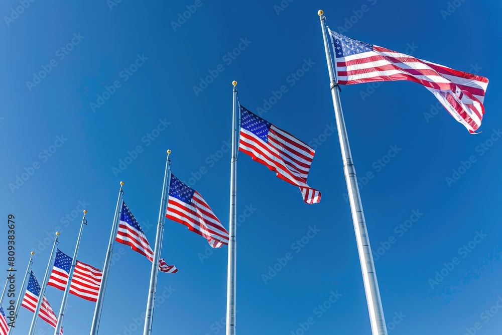 American flags waving in the wind on a background of blue sky. American flags waving in the wind on a background of blue sky.