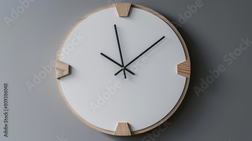 a wooden clock with a black hand on a white wall