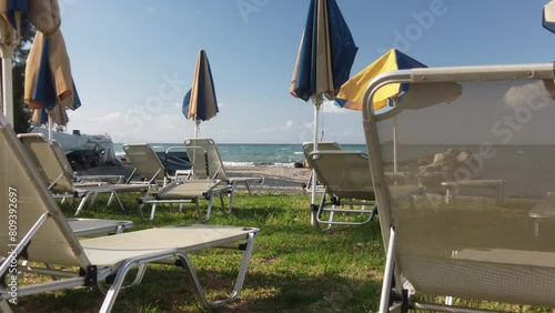 sunbeds and parasols on the beach of Argassi in Zakynthos photo