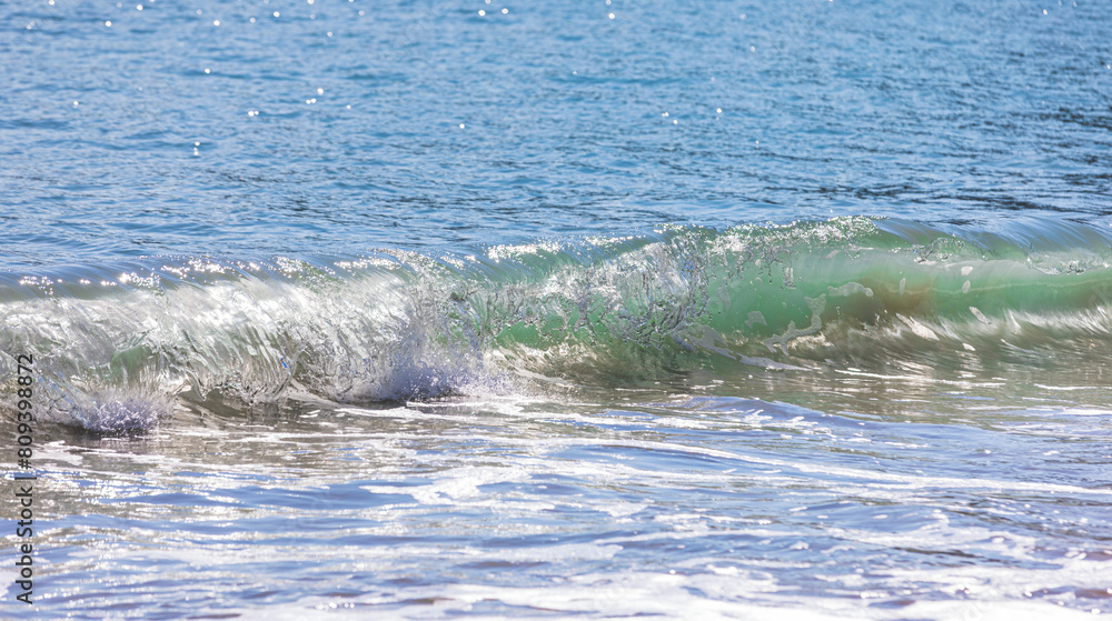Rough waves of the emerald sea seen from the beach. front view Rough waves of the emerald sea seen from the beach. front view