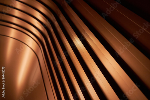 Curved metallic corridor bathed in warm light