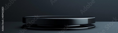 Glossy black circular podium in a dark setting, ideal for showcasing luxury electronics or highend jewelry